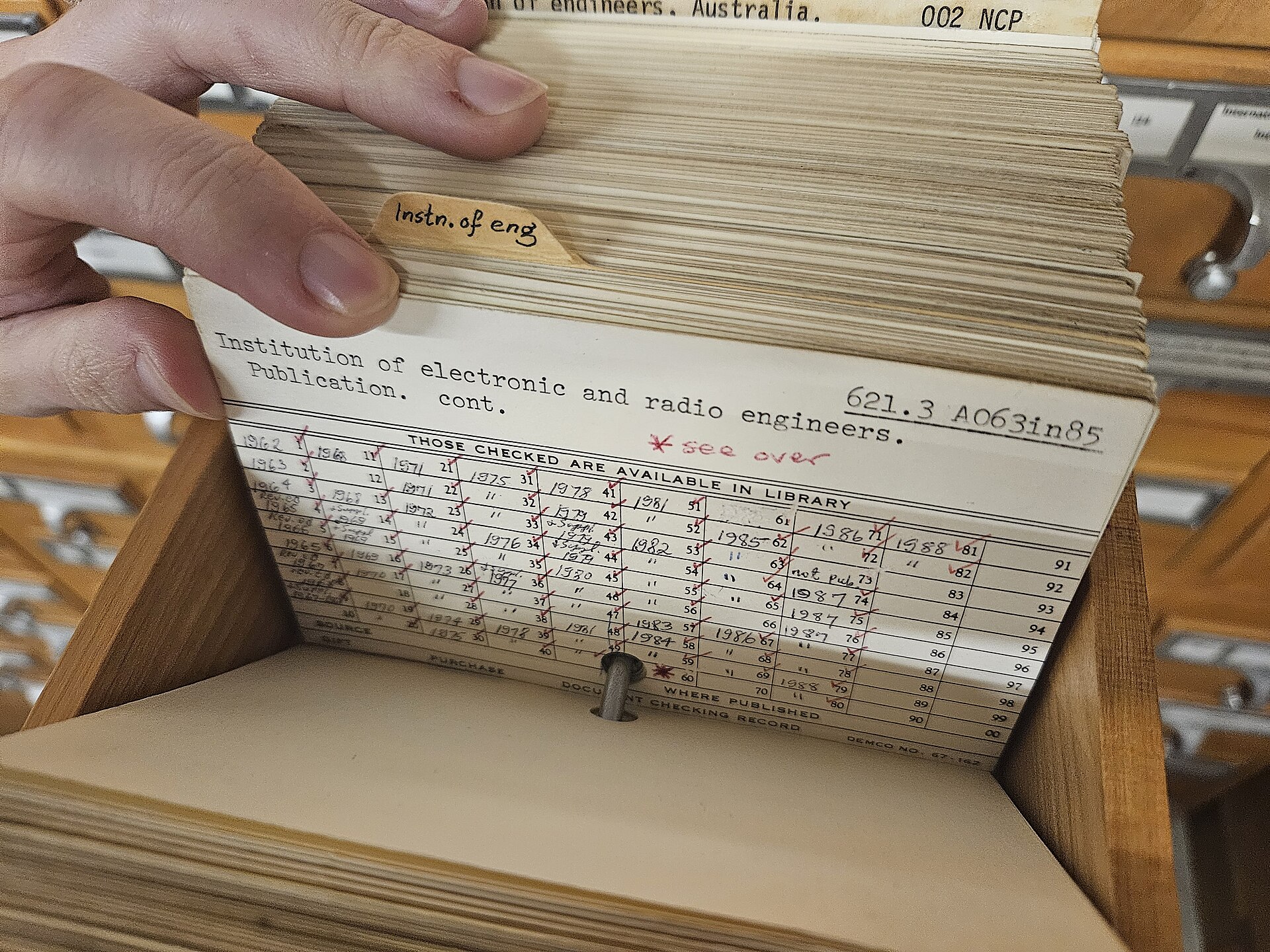 Hölzerner Zettelkatalog einer Bibliothek mit vielen beschrifteten Schubladen und Messinggriffen